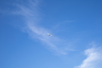 a small plane seen far into the blue sky.