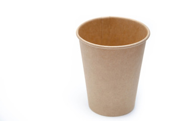 Brown paper cup for coffee, tea, a drink from environmental materials on a white background. A small cup in macro is on the right. Front view and top view, bottom visible. Place for text on the left