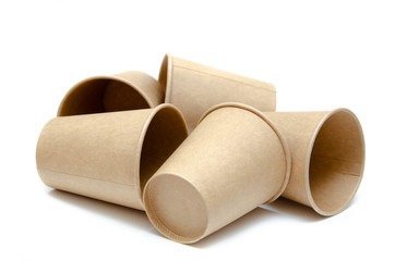 Brown paper cup for coffee, tea, a drink from environmental materials on a white background. A bunch of glasses. Glasses lie on their side in a circle in the form of a ring. Front and top view. Macro