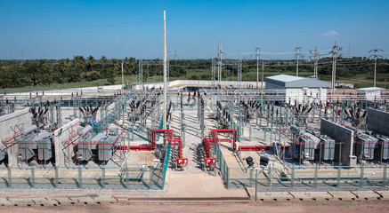 Power transformer in high voltage switchyard in modern electrical substation, Aerial top view...