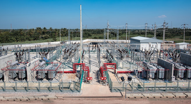 Power transformer in high voltage switchyard in modern electrical substation, Aerial top view electric substation industry, View from above high voltage tower electricity industry business station