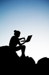 Young Girl working on laptop at outdoor