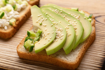 Sliced avocado on toast bread with sesame close up. Avocado on toast. Healthy eating.