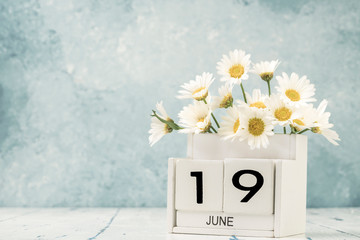 White cube calendar for june decorated with daisy flowers