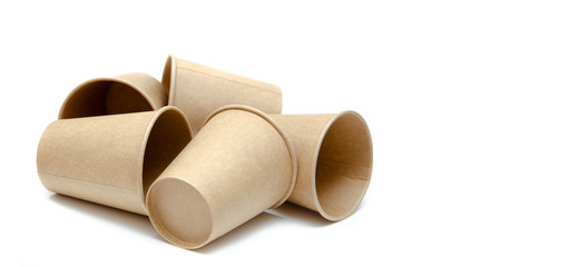 Brown paper cup for coffee, tea, a drink from environmental materials on a white background. A bunch of glasses. Glasses lie on their side in a circle in the form of a ring. Front and top view. Macro