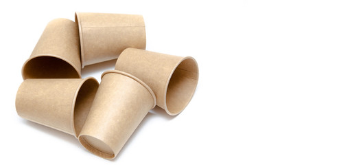 Brown paper cup for coffee, tea, a drink from environmental materials on a white background. A bunch of glasses. Glasses lie on their side in a circle in the form of a ring. Front and top view. Macro