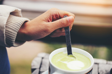 The hand that is making hot green tea In the morning