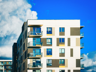 Facade of apartment house copy space blue sky clouds_4x3