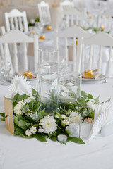 Lush floral arrangement of white chrysanthemum flowers and candles on table, copy space. Luxury wedding decorations