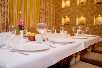 Holiday dinner table served for banquet in restaurant, copy space