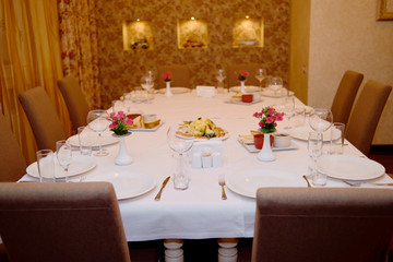 Holiday dinner table served for banquet in restaurant, copy space