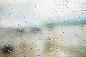 Surface of the glass window with water droplets. Abstract bright background. Copyspace.