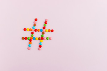 Hashtag sign made of colorful candies. Social media concept. Copy space for text.