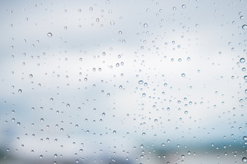 Surface of the glass window with water droplets. Abstract bright background. Copyspace.
