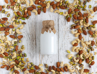 Vegan milk from nuts on rustic wooden table