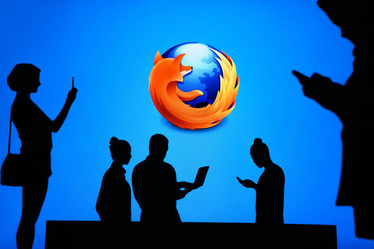 NEW YORK, USA, 25. MAY 2020: Mozilla Firefox web browser Group of business people chat on mobile phone and laptop. Company logo on screen in background
