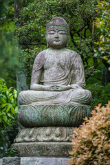 Fototapeta na wymiar Statue of Buddha in the Gardens at Ryoanji, Kyoto, Japan