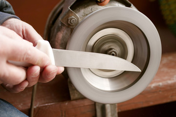 Sharpening a knife on an old emery machine