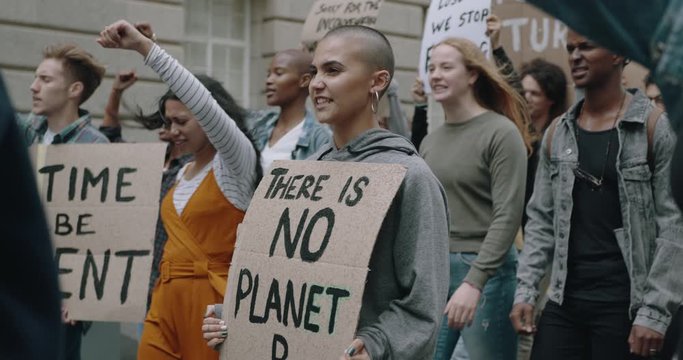 Group of demonstrators on road. Young people from a different culture and race fight for climate change, global warming and environmental conservation.
