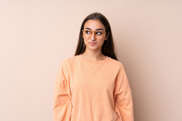 Young girl over isolated background standing and looking to the side