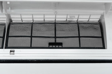 The guy cleans the filter of the home air conditioner from dust. Very dirty air conditioner filter....