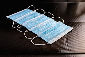 Disposable medical masks to protect against infections and viruses. White and blue layers with...