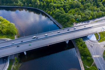 panoramic views of the river with a forest and reflection of clouds in the river taken from a drone