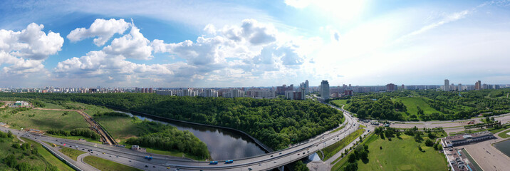 panoramic views of the river with a forest and reflection of clouds in the river taken from a drone