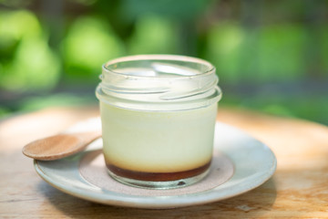 Homemade caramel custard pudding in a glass bottle