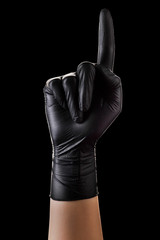 Hand in black gloves with the index finger pointing up on black