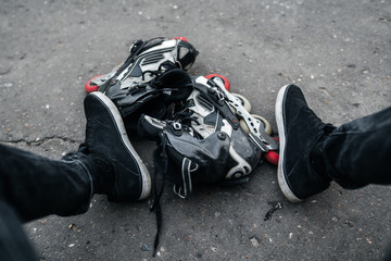 roller skates and feet on asphalt