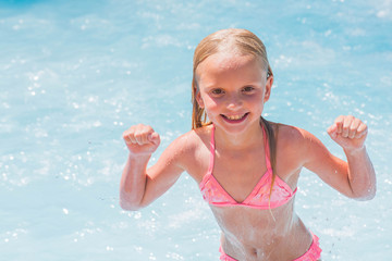 Child on water slide at aquapark. Summer holiday.