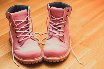 Pink Shoes And Shoelaces In The Form Of Heart At Wooden Floor