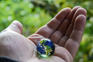 Earth in hand, human hand holding planet earth