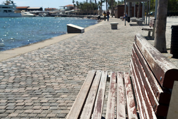 Obraz premium Empty bench on seafront promenade in Paphos, Cyprus