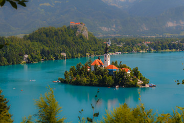 View of the island with a temple on Lake Bled. Tilt Shift Effect. Miniature effect. - Powered by Adobe