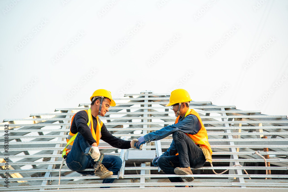 Poster Handyman working on install the roof,Roofer builder working on roof structure of building on construction site.