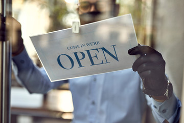 Close-up of cafe owner reopening after coronavirus epidemic.