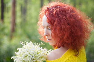 red haired romantic girl with bouquet of white flowers with naked shoulder in yellow sweater