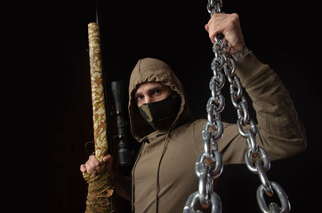 guy in a mask and hood with chains
