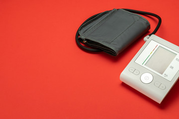 Pressure meter. Patient test hypertension from medical sphygmomanometer. Health monitor for check doctor blood pressure isolated on red background. Hospital diagnostic technology.