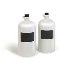 White porcelain bottles with black blank labels and black corks isolated on white background for mock-up. 