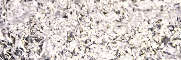 Foil aluminum crushed texture. Metal material background. Silver grunge decoration. Material pattern. Crinkle chrome paper. Fabric shine sheet. Grey color. Horizontal banner. Copyspace for text