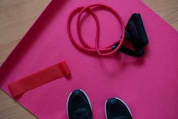 Home workout equpment.  Workout from home durig 2020 self-isolation. Yoga matt,  training sneakers, ropes.