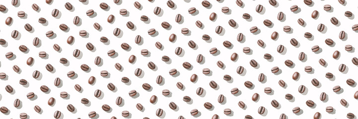 Many coffee beans at white background. Isolated pattern seeds. Roast arabica restaurant concept. Taste energy brown morning beverage. Cafe wallpaper. Horizontal banner. Hard shadows