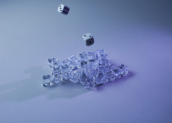 Set of ice cubes and dice falling on them,
