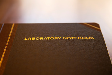Data and research laboratory notebook on wood table with copy space available