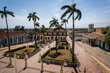 Plaza Mayor consisting of a park with palm trees and colonial buildings, Trinidad, Cuba