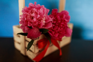Peonies and roses. Peonies in a wooden box.