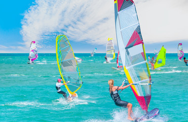 Beautiful cloudy sky with Windsurfer Surfing The Wind On Waves In Alacati - Cesme, Turkey